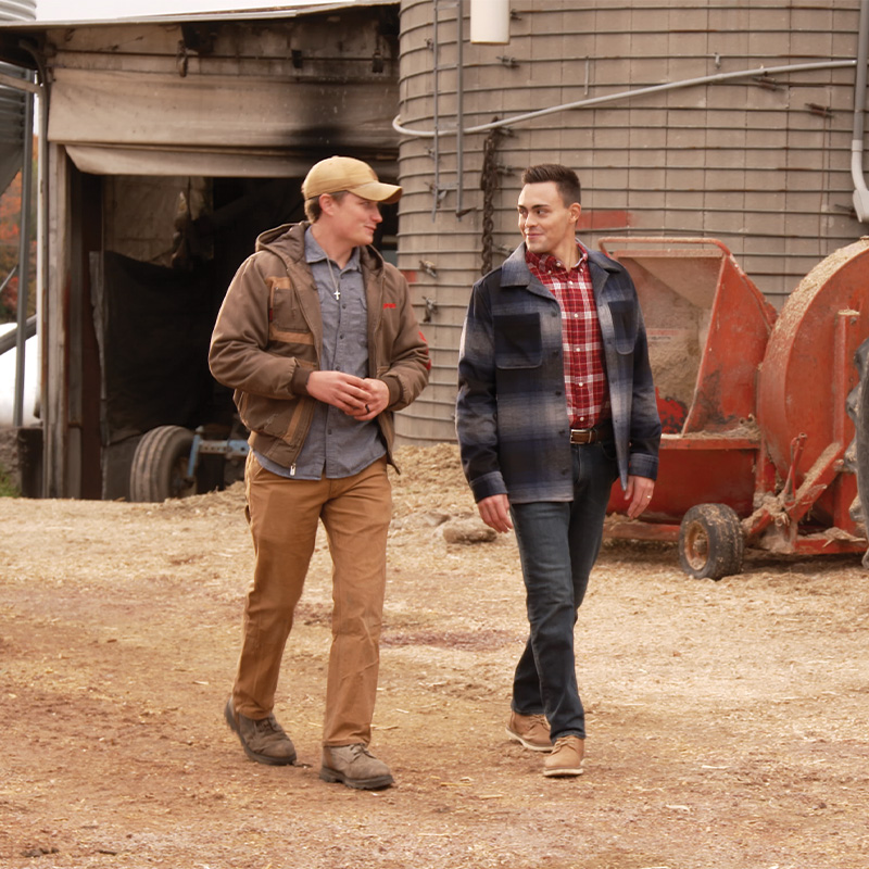 Michael Alfonso walking a rural property while speaking with a voter