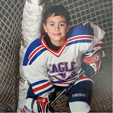 Michael Alfonso dressed in hockey equipment as a boy