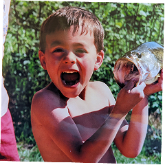 Michael Alfonso as a boy, holding a freshly caught fish