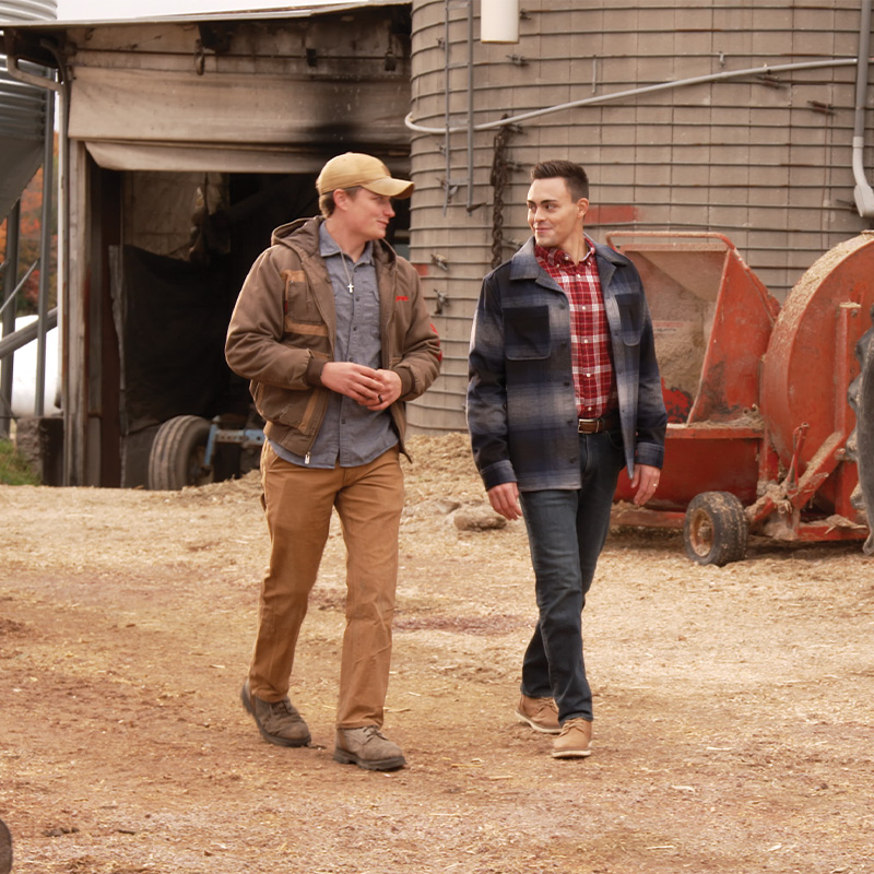 Michael Alfonso walking a rural property while speaking with a voter