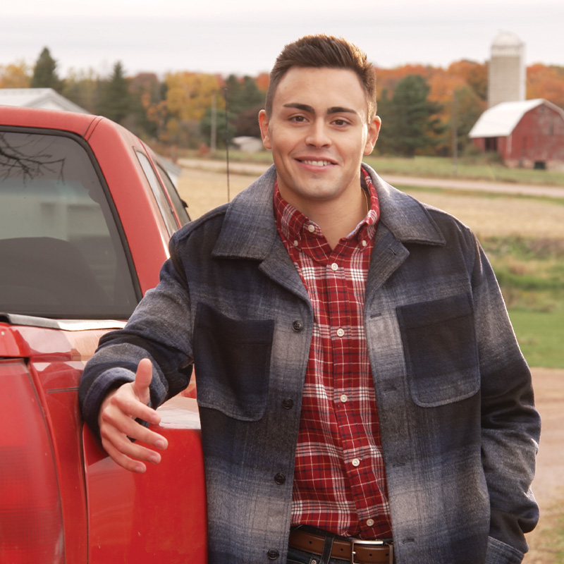 Michael Alfonso leaning against a red truck